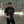 Photo of a man standing in a parking lot wearing sunglasses and the Bullzerk DAL Charcoal tshirt. 
