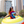Photo of a woman in sunglasses and the Bullzerk Dallas Script Tie Dye tshirt standing in an inflatable tube outside. 
