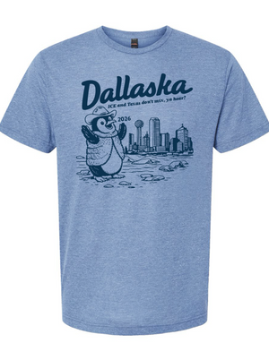 Light Blue t-shirt with a graphic of a penguin in front of the Dallas skyline and text reading 