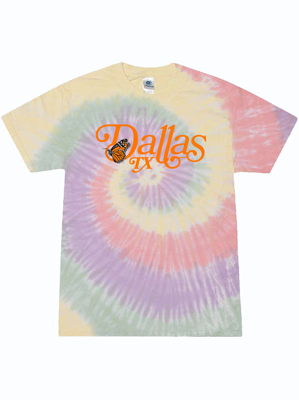 Light colored tie dye tshirt with graphic print of a monarch butterfly and text reading "Dallas, TX" in orange letters.