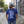 Man wearing a Bullzerk Ceedee Rollin tshirt, standing on a street. 