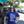 Woman wearing a Bullzerk Ceedee Rollin t-shirt, standing on a street with storefronts and cars in the background.