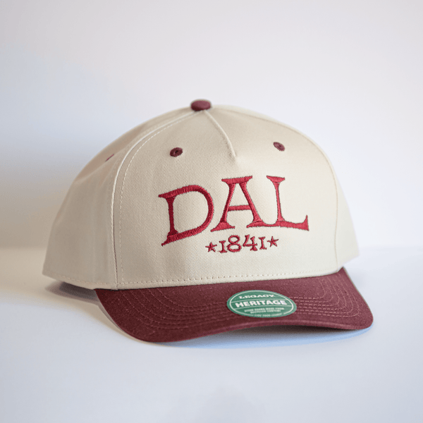 Embroidered DAL Hat in maroon and cream colors, featuring the year '1841' and a structured fit, perfect as a Texas themed gift, a Dallas souvenir or Texan gift, showcasing local craftsmanship.