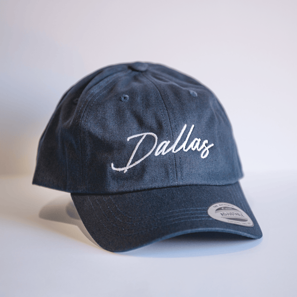 Embroidered Dallas Script Hat - Navy, a stylish cotton cap perfect for any Texan. This Texas themed gift features a classic design and is ideal for souvenirs from Texas, making it a perfect Dallas souvenir or a unique Texan gift.