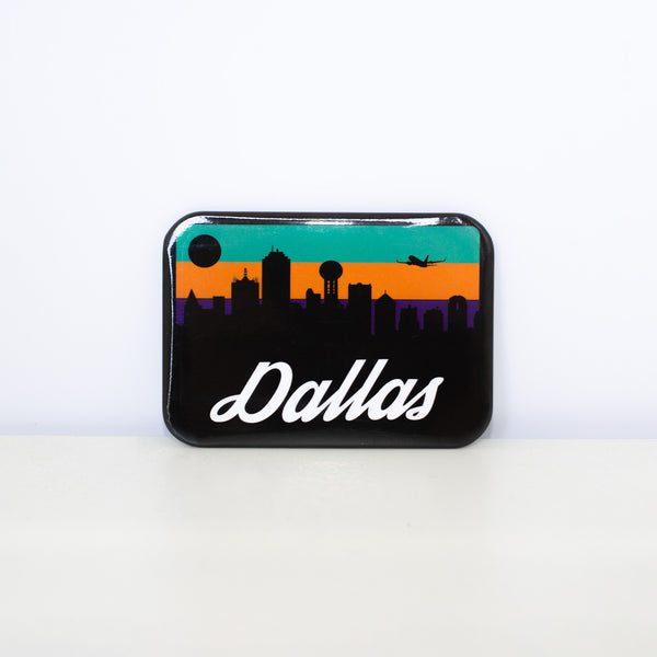 Rectangular, black magnet with rounded corners and the Dallas Skyline design. 