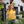Woman standing near bushes wearing sunglasses and a Bullzerk Flowers of Texas tshirt. 