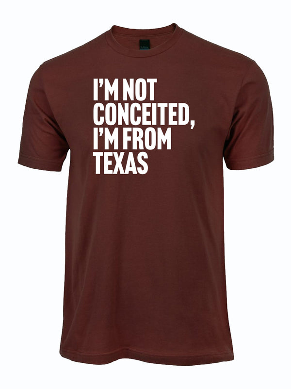 Maroon T-shirt featuring the phrase 'I'M NOT CONCEITED, I'M FROM TEXAS', perfect for showcasing Texas pride. This stylish tee makes a great Texas themed gift, ideal for souvenir lovers and anyone seeking Texas Made Gifts, Dallas souvenirs, or unique Texan gifts.