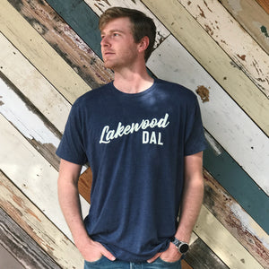 Man standing against a wooden wall, wearing a Bullzerk Lakewood DAL tshirt. 