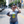 Photo of a woman wearing sunglasses and the Bullzerk Dallas Pineapple tshirt standing in the street outside. 
