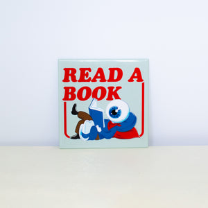 Square, mint colored magnet with Read A Book design.