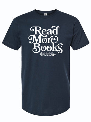 Stylish navy blue t-shirt featuring the slogan 'Read More Books' in bold white lettering, representing a partnership with the Dallas Public Library. This Texas themed gift is perfect for book lovers and makes a thoughtful Texas Made Gift or souvenir from Texas, showcasing pride for your local library as a unique Dallas souvenir. Ideal for anyone seeking authentic Texan gifts.