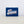 Rectangular, blue magnet with Texas Script design.