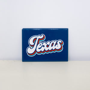 Rectangular, blue magnet with Texas Script design.