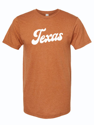 Texas Script Orange t-shirt featuring a bold 'Texas' design in white, perfect as a Texas themed gift. This stylish tee represents Texas Made Gifts, ideal for souvenirs from Texas and the perfect Dallas souvenir to show your Texan pride with unique Texan gifts.