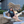 Woman sitting on a large metal statue of a robot, wearing a Bullzerk Texas Silhouette tshirt. 