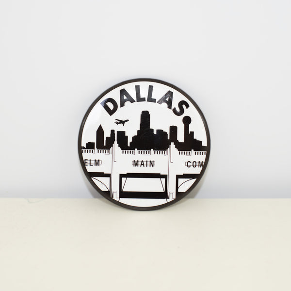 Circular, black and white magnet with Triple Underpass design.