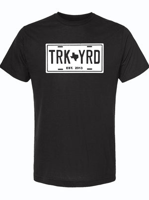 Truck Yard License Plate design on a black unisex fine jersey tee, perfect for showcasing Texas pride. A great Texas themed gift, this shirt makes an ideal choice for souvenirs from Texas, especially for fans of Dallas. Celebrate your love for the Lone Star State with this stylish Texan gift.