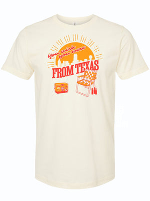A cream-colored unisex fine jersey t-shirt featuring the design 'You Wish You Were From Texas' with a sunset and grill motif, perfect for showing off Texas pride. This Texas themed gift is an ideal choice for those seeking Texas Made Gifts, souvenirs from Texas, or authentic Dallas souvenirs and Texan gifts.