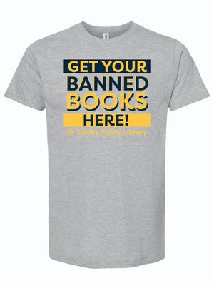 Get Your Banned Books Here t-shirt featuring bold text design, perfect for book lovers and supporters of the Dallas Public Library. A great Texas themed gift for avid readers, this shirt represents Texas pride and makes for an ideal souvenir from Texas or Texan gift.