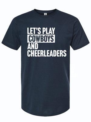 A navy blue t-shirt featuring the phrase 'Let's Play Cowboys and Cheerleaders' in bold white letters. This shirt embodies Texas culture, making it a perfect Texas themed gift, ideal for anyone looking for Texas Made Gifts, souvenirs from Texas, or a dallas souvenir. Great for showcasing your Texan pride!