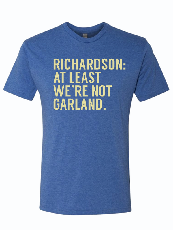 Richardson: At Least We're Not Garland t-shirt featuring bold text on a blue fabric, perfect as a Texas themed gift, showcasing Texas Made Gifts, ideal souvenirs from Texas, a great Dallas souvenir, and a fun option for Texan gifts.
