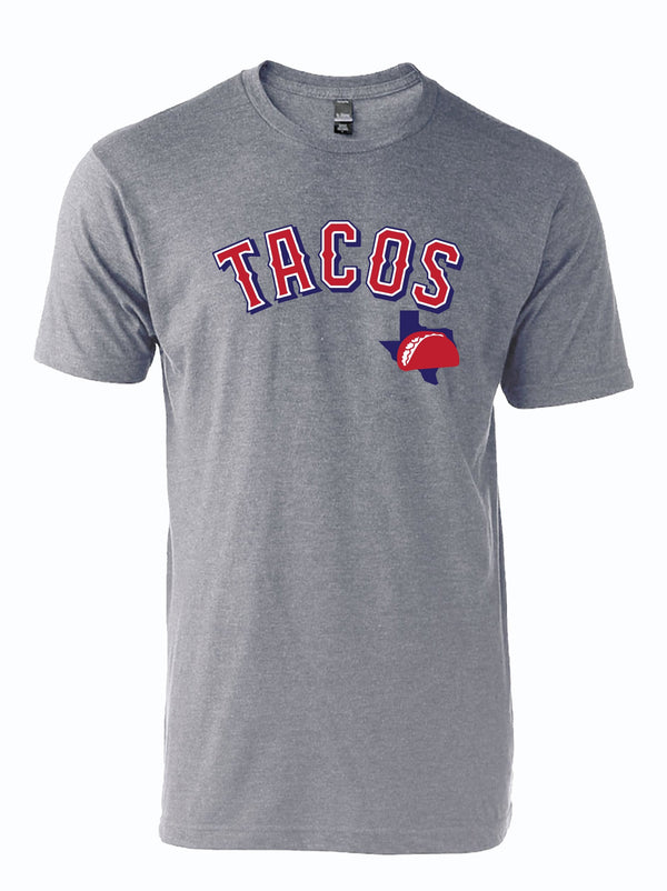 A gray unisex tri-blend t-shirt featuring the word 'Tacos' in bold red and blue letters, showcasing a Texas-themed design. This stylish shirt makes a great Texas themed gift for anyone who loves tacos, perfect as a souvenir from Texas, especially for those looking for unique Texan gifts or a Dallas souvenir.