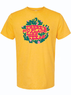 Yellow tshirt with graphic design of cactus wrapping around text reading 'There's No Place Like Texas' in pink letters.