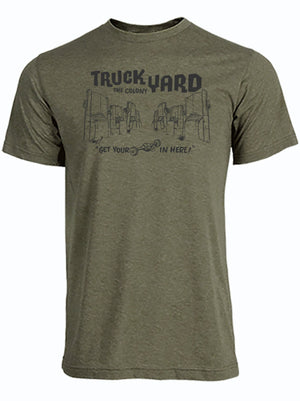 Olive green tshirt with a graphic design of cars sticking up from the ground and the Truck Yard The Colony Logo in black letters. 