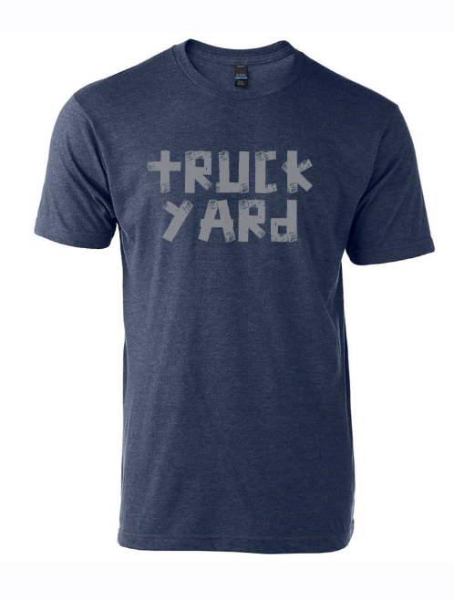 Denim blue tshirt with text reading "Truck Yard" in gray duct tape font. 